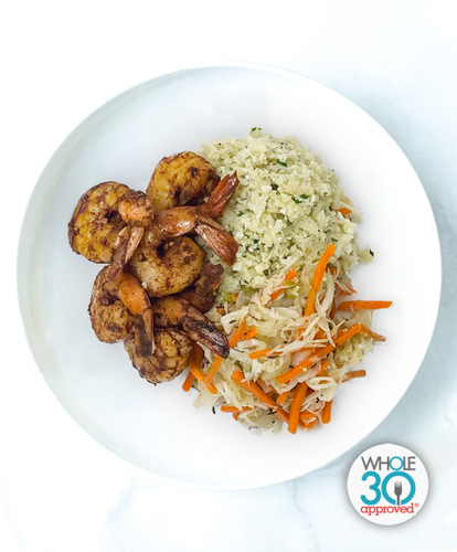 A plate of BBQ Shrimp With Cauliflower Rice and Caribbean Carrot Slaw