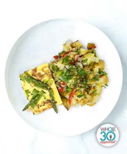 A plate of Bacon And Asparagus Frittata with Yukon Potato Hash