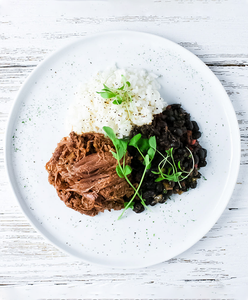 A plate of Barbacoa Beef with Black Beans and Cilantro Rice