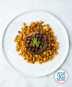 A plate of a Beef Burger with Sweet Potato Hash