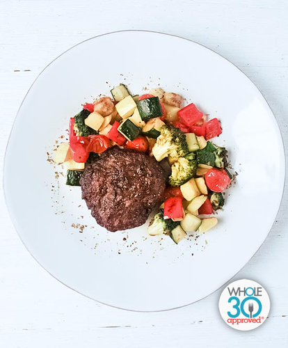 A plate of a Beef Burger with Roasted Summer Vegetables