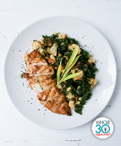 A plate of Citrus and Herb Chicken with Roasted Red Pepper Pesto, Cauliflower and Kale