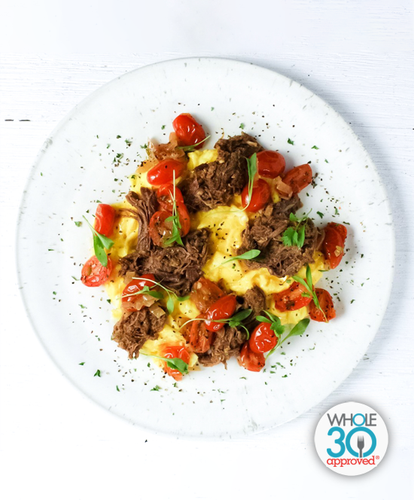 A plate of Beef Barbacoa and Scrambled Eggs with Roasted Pico De Gallo
