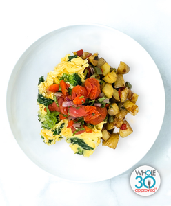 A plate of Spinach And Broccoli Scrambled Eggs With Grits And Roasted Pico De Gallo