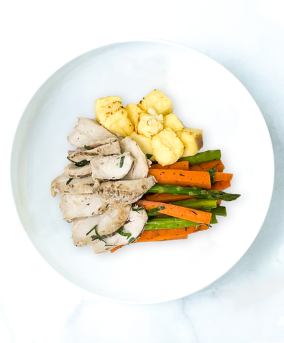 A plate of Tuscan Chicken With Asparagus, Carrots And Polenta Croutons
