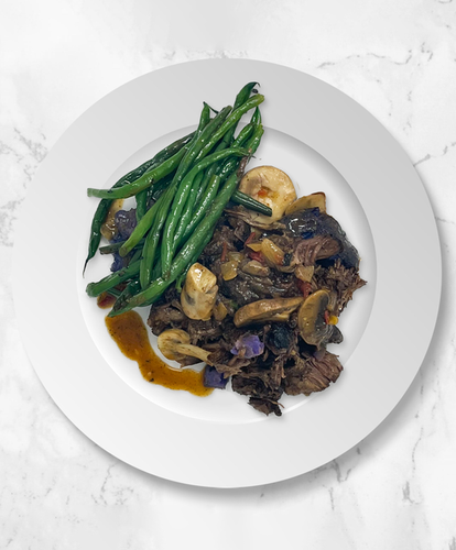 A plate of Worcestershire Beef With Mushroom Gravy and Potato Smash