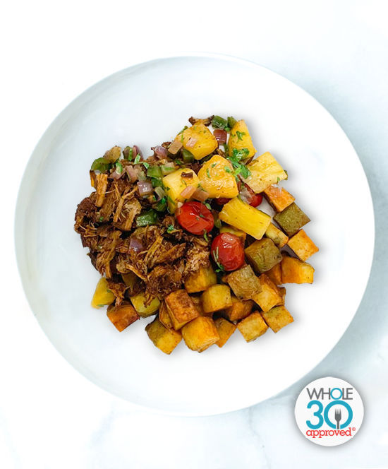 A plate of Pulled Pork Al Pastor with Roasted Pineapple Salsa and Paprika Potatoes